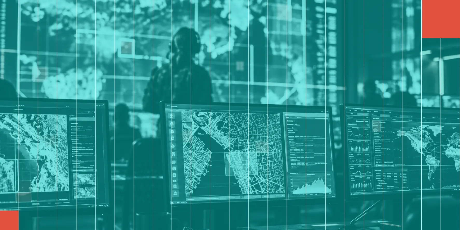 Operations center with analysts and map displays across multiple monitors